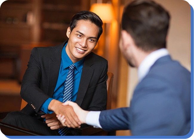 Two men shaking hands in a room.