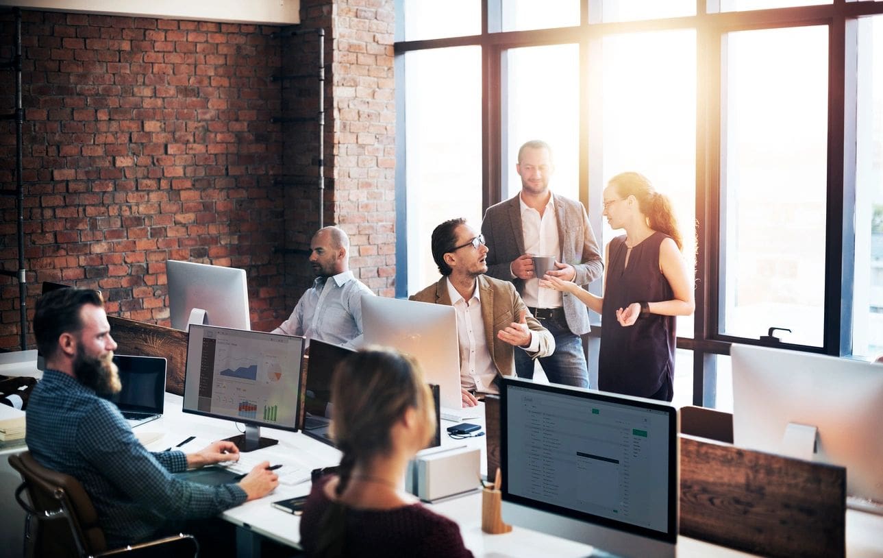 A group of people in an office setting.